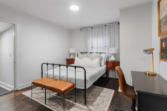 bedroom with crown molding and dark wood-type flooring