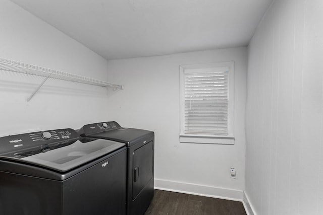 clothes washing area featuring dark wood-type flooring and washer and dryer