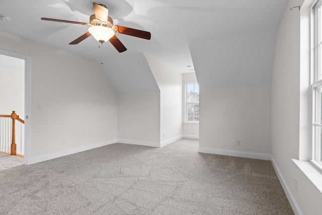 bonus room featuring ceiling fan, light carpet, and vaulted ceiling