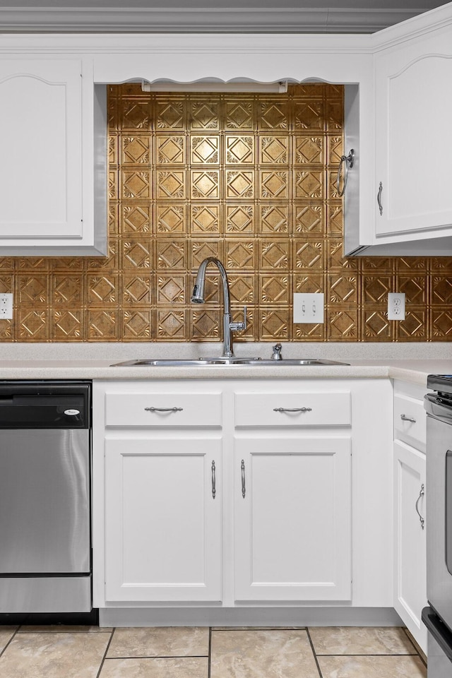 kitchen featuring dishwasher, sink, light tile patterned floors, white range, and white cabinets