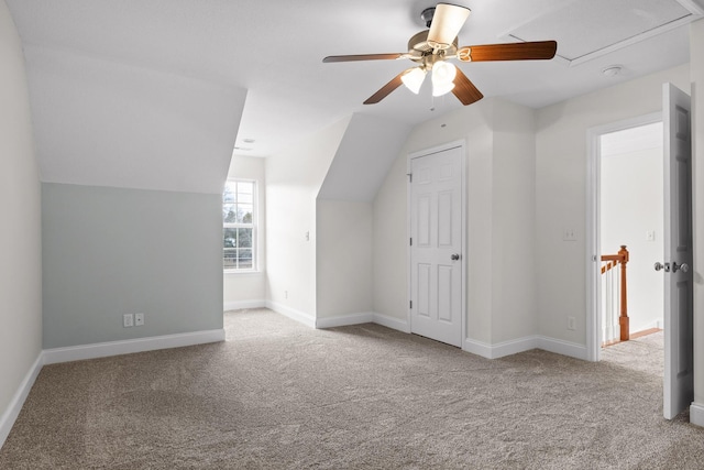 bonus room with light carpet, vaulted ceiling, and ceiling fan