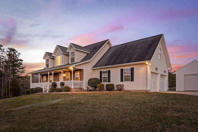 cape cod-style house featuring a yard, a porch, and a garage