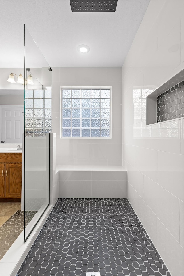 bathroom with tile patterned flooring, vanity, and a shower