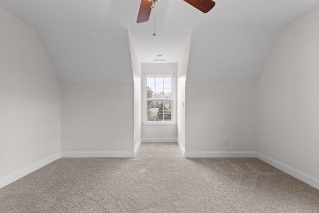 additional living space with ceiling fan, light carpet, and vaulted ceiling