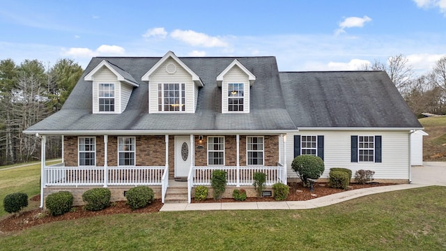 new england style home featuring a front lawn and a porch