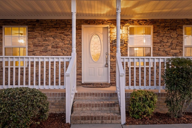 entrance to property featuring a porch