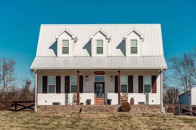 cape cod-style house with covered porch