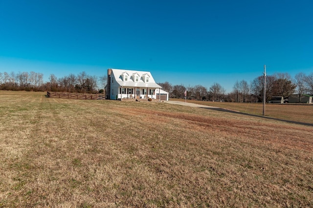 view of yard featuring a porch and a rural view