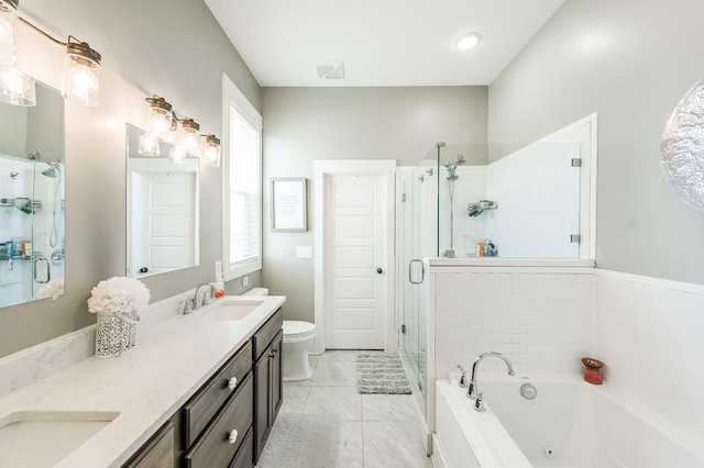 full bathroom featuring plus walk in shower, vanity, toilet, and a healthy amount of sunlight