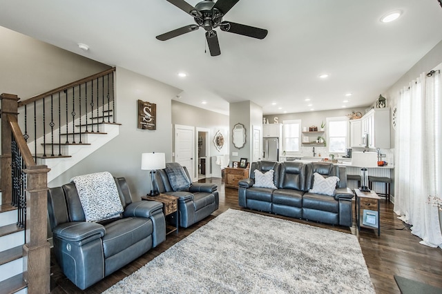 living room featuring dark hardwood / wood-style flooring and ceiling fan