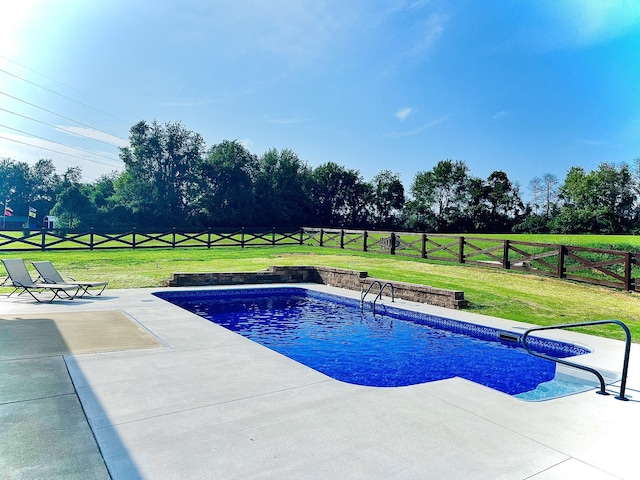 view of swimming pool with a lawn and a patio