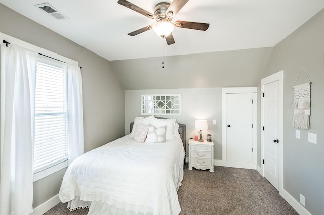 carpeted bedroom with ceiling fan and vaulted ceiling