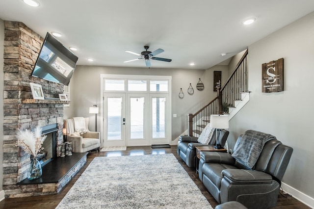 living room featuring plenty of natural light, ceiling fan, and dark hardwood / wood-style flooring