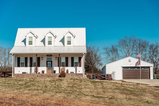 view of front of property with an outdoor structure, a front lawn, a porch, and a garage