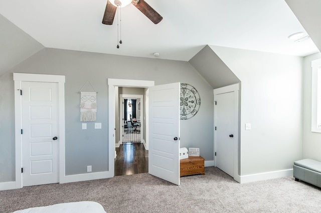 unfurnished bedroom with carpet flooring, ceiling fan, and vaulted ceiling