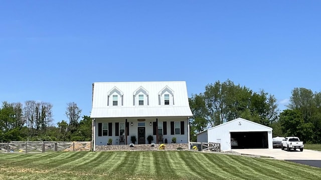 cape cod house with a porch, an outbuilding, a front yard, and a garage