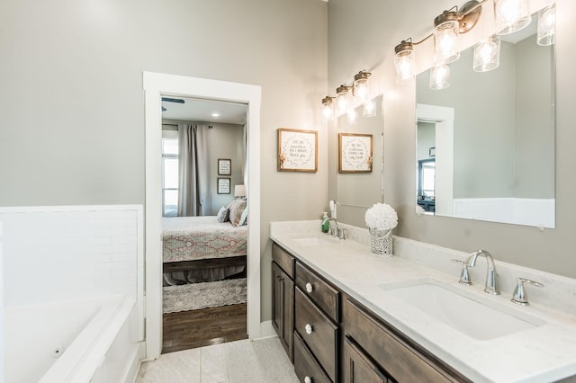 bathroom featuring a washtub, vanity, and tile patterned flooring