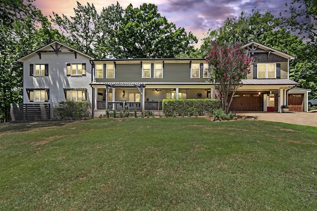 view of front facade with covered porch and a lawn