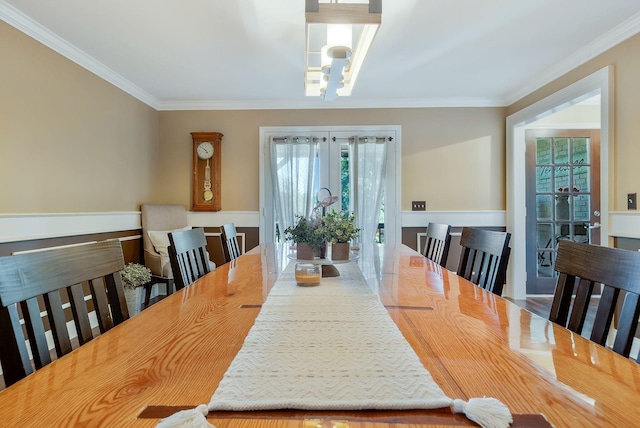 dining area featuring a chandelier and ornamental molding