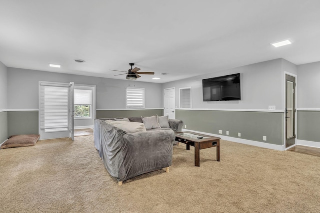 living room featuring carpet and ceiling fan