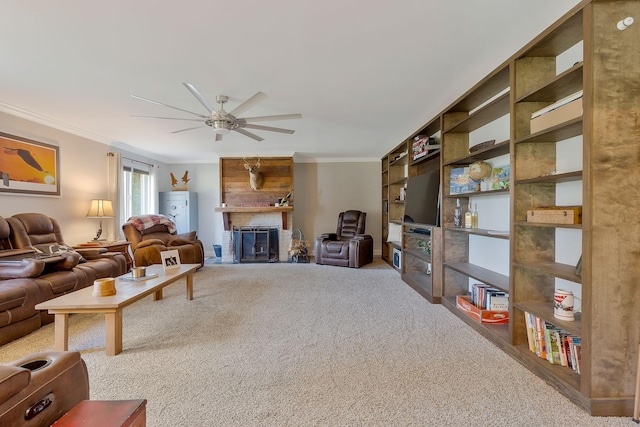 living room with ceiling fan, crown molding, carpet, and a brick fireplace