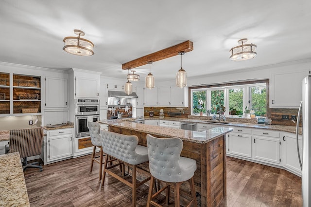 kitchen featuring white cabinetry, light stone countertops, pendant lighting, and stainless steel appliances