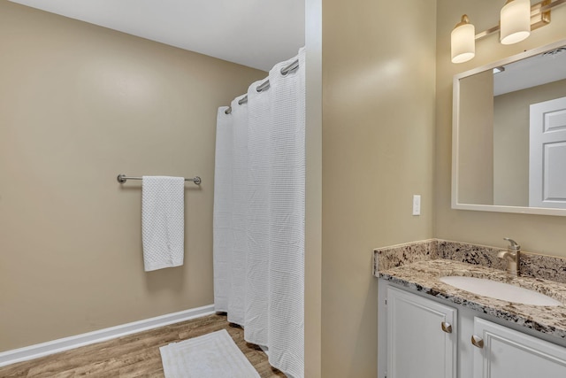 bathroom with a shower with curtain, vanity, and wood-type flooring