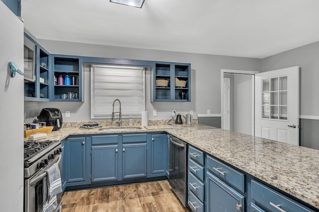 kitchen with blue cabinets, sink, light hardwood / wood-style flooring, light stone counters, and stainless steel appliances