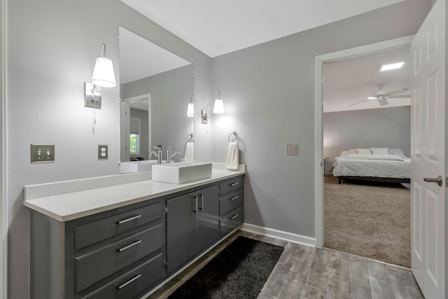 bathroom featuring ceiling fan, vanity, and hardwood / wood-style flooring