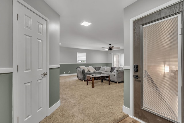 living room with light carpet and ceiling fan