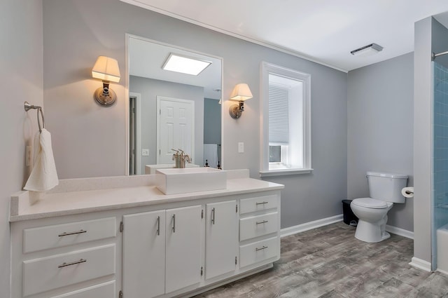 full bathroom with washtub / shower combination, toilet, vanity, and hardwood / wood-style flooring