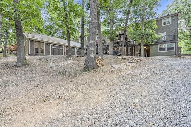 rear view of house featuring a wooden deck