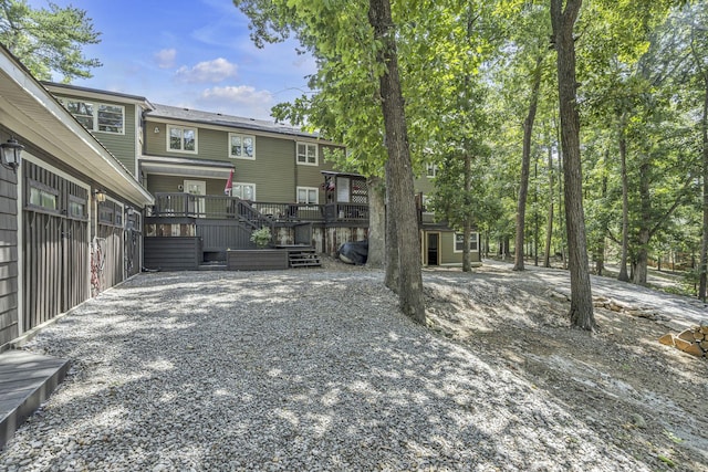 back of house featuring a wooden deck