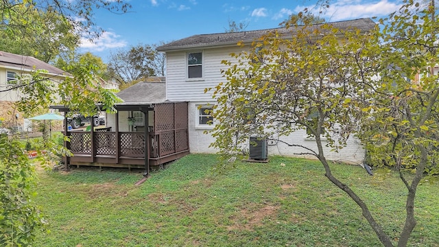 back of house with a yard, a deck, and central AC unit