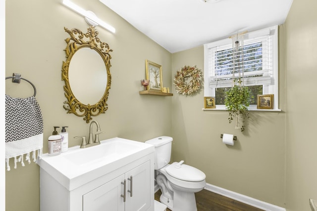 bathroom with vanity, hardwood / wood-style flooring, and toilet