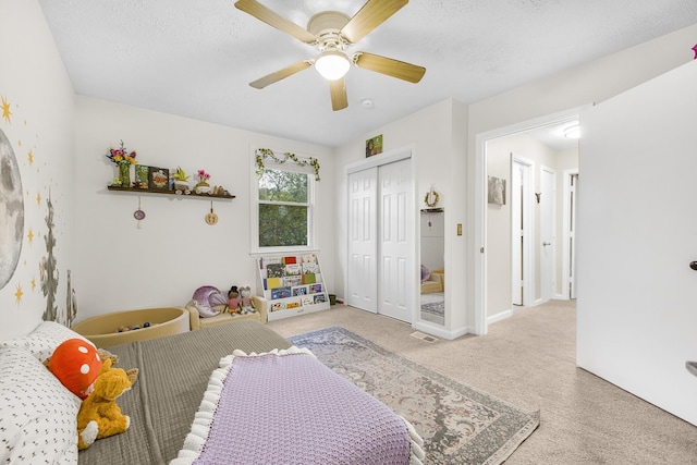 bedroom with a textured ceiling, a closet, and ceiling fan