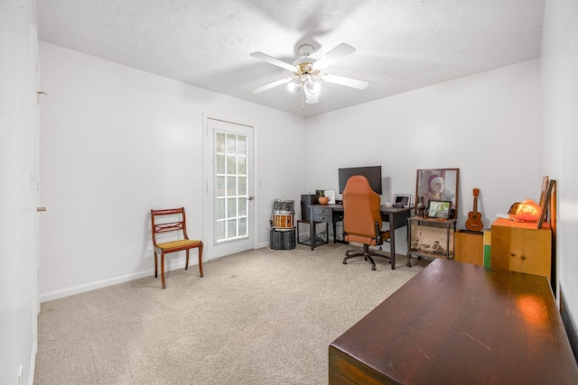 office area with carpet, a textured ceiling, and ceiling fan