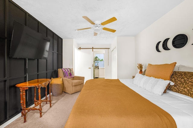 carpeted bedroom featuring ceiling fan and a textured ceiling