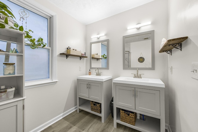 bathroom with vanity, a textured ceiling, and hardwood / wood-style flooring