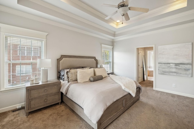 carpeted bedroom featuring a raised ceiling, multiple windows, ceiling fan, and ornamental molding