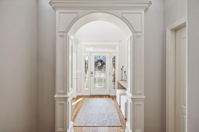 foyer entrance featuring ornate columns and hardwood / wood-style flooring