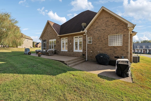 rear view of property featuring french doors, a yard, and a patio area