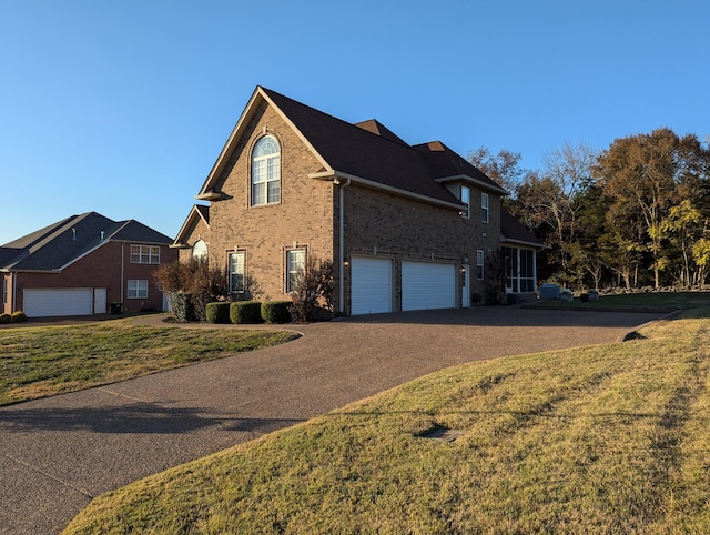 view of front of home featuring a front yard and a garage