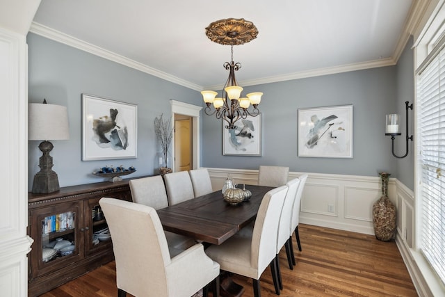 dining area with a chandelier, dark hardwood / wood-style flooring, and ornamental molding