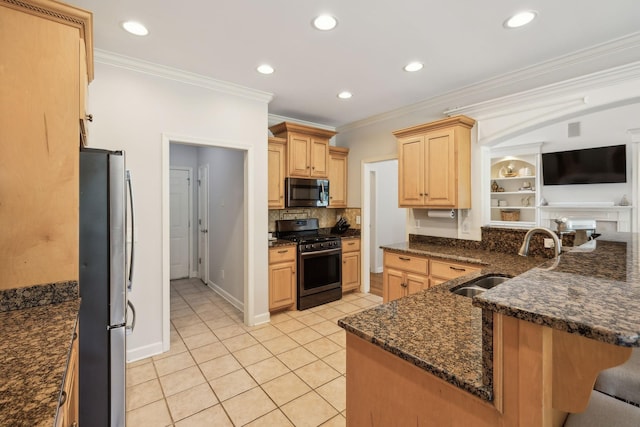 kitchen with kitchen peninsula, appliances with stainless steel finishes, ornamental molding, and sink