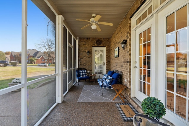 unfurnished sunroom with ceiling fan and wooden ceiling