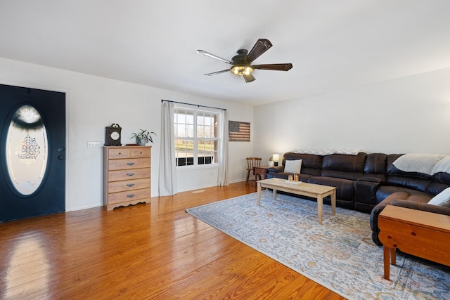 living room featuring ceiling fan and wood-type flooring