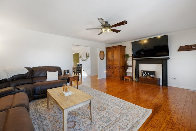 living room with hardwood / wood-style flooring and ceiling fan