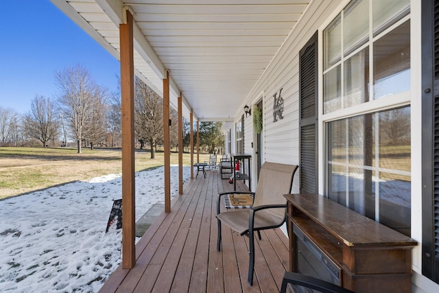 snow covered deck with covered porch