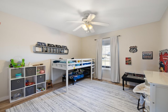 bedroom with ceiling fan and light hardwood / wood-style flooring